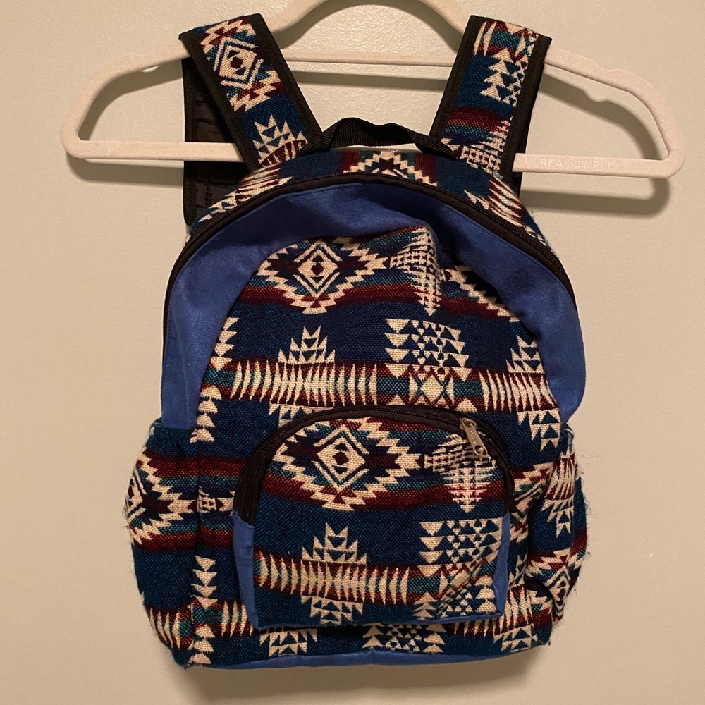 A blue patterned backpack made/bought in Ecuador